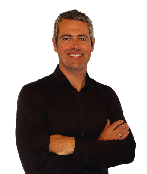 Smiling person in a dark shirt, arms crossed, against a transparent background